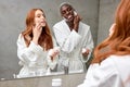 young interracial multi-ethnic diverse man and woman spend morning routine in bathroom together