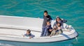 Young inuit children on small fishing boat from remote settlement of Aappilattoq in Prince Christian Sound, South Greenland