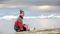 Young inuit woman in traditional clothing posing for photos on the shore of the ocean, Royalty Free Stock Photo