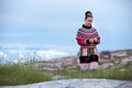 Young inuit woman in traditional clothing posing for photos in a small Greenlandish village. Royalty Free Stock Photo
