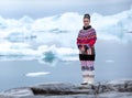 Young inuit woman in traditional clothing posing for photos in a small Greenlandish village. Royalty Free Stock Photo