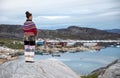 Young inuit woman in traditional clothing posing for photos in a small Greenlandish village. Royalty Free Stock Photo