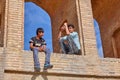 Young Iranians sit under arch of bridge Allahverdi Khan, Isfahan