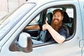 Young Irish Man Smiling Happy Driving Car Doing Ok Sign With Thumb Up At The City