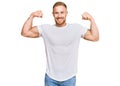 Young irish man wearing casual clothes showing arms muscles smiling proud Royalty Free Stock Photo