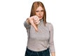 Young irish woman wearing casual clothes looking unhappy and angry showing rejection and negative with thumbs down gesture Royalty Free Stock Photo