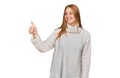 Young irish woman wearing casual winter sweater looking proud, smiling doing thumbs up gesture to the side Royalty Free Stock Photo