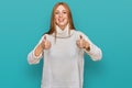 Young irish woman wearing casual winter sweater success sign doing positive gesture with hand, thumbs up smiling and happy Royalty Free Stock Photo