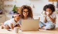 Young irritated African-American mother freelancer trying to work while working remotely with kids Royalty Free Stock Photo