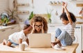 Young irritated African-American mother freelancer trying to work while working remotely with kids Royalty Free Stock Photo