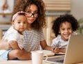 Young irritated African-American mother freelancer trying to work while working remotely with kids Royalty Free Stock Photo