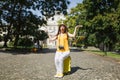 Young irritated angry traveler tourist woman in yellow clothes sitting on suitcase hold city map spreading hands outdoor Royalty Free Stock Photo