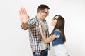 Young irritated dissatisfied couple, woman and man in 3d glasses watching movie film on date, showing stop gesture with