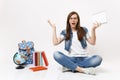 Young irritated woman student in glasses spreading hands holding pencil, notebook sitting near globe, backpack, school Royalty Free Stock Photo