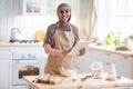 Young Islamic Lady In Hijab And Apron Using Digital Tablet In Kitchen