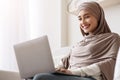 Young Islamic Woman In Hijab Working On Laptop At Home Royalty Free Stock Photo