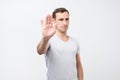 Young italian man shows stop timeout or refusal sign with hand Royalty Free Stock Photo