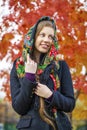 Young Italians in coat and knit a scarf on her head