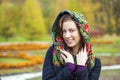 Young Italians in coat and knit a scarf on her head