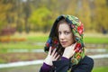 Young Italians in coat and knit a scarf on her head