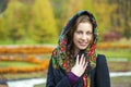 Young Italians in coat and knit a scarf on her head