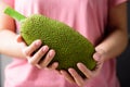 Young jackfruit holding by hand