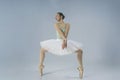 young Japanese ballerina demonstrates balance and plasticity while standing in a plie