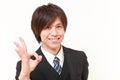 Young Japanese businessman showing perfect sign Royalty Free Stock Photo