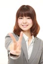 Young Japanese woman showing a victory sign Royalty Free Stock Photo