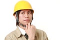 Young Japanese construction worker worries about something