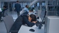 Young Japanese Manager is Tired at his Work Place with Desktop Computer and Falls Asleep. Diverse Royalty Free Stock Photo