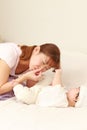 Young Japanese mom changing her baby`s diaper Royalty Free Stock Photo