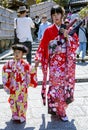 A young Japanese mother with a little daughter in bright kimono