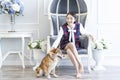 A young Japanese woman is sitting with a Shiba Inu in the living room. Young female looking camera Royalty Free Stock Photo