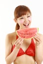 Young Japanese woman wearing bikini with watermelon