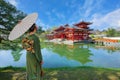 Young Japanse woman with traditional Kimono dress with the Phoenix Hall of Byodo-in Temple in Kyoto, Japan Royalty Free Stock Photo