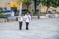 A young leads an elderly under the arm of an early morning for the morning prayer in the Jewish quarter in the old city of