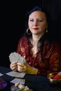 Young Jewish fortuneteller and clairvoyant divines on playing cards.