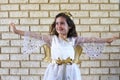 Young Jewish girl dressed up in angel costume on Purim Jewish holiday