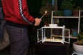 Young jewish man lighting menorah, celebrating hanukkah, lighting Hanukka candles. In Israel, many people use glass