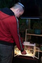 Young jewish man lighting menorah, celebrating hanukkah, lighting Hanukka candles.