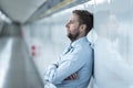 Young jobless business man suffering depression leaning on street underground wall alone looking desperate in Emotional pain Royalty Free Stock Photo