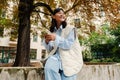 Young asian girl using mobile phone while sitting in courtyard Royalty Free Stock Photo