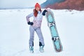 Young joyful snowboarder woman smiling and posing Royalty Free Stock Photo