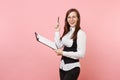 Young joyful successful business woman in glasses holding clipboard tablet with papers document and pen on pink Royalty Free Stock Photo
