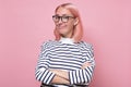 Young joyful woman with pink dyed hair and glasses smiling at camera. Royalty Free Stock Photo