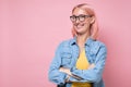 Young joyful woman with pink dyed hair and glasses smiling at camera. Royalty Free Stock Photo