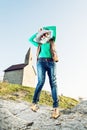 Young joyful woman with stylish hat and an old romanesque church Royalty Free Stock Photo