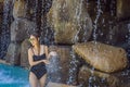 Young joyful woman under the water stream, pool, day spa, hot springs Royalty Free Stock Photo