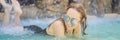 Young joyful woman under the water stream, pool, day spa, hot springs BANNER, LONG FORMAT Royalty Free Stock Photo